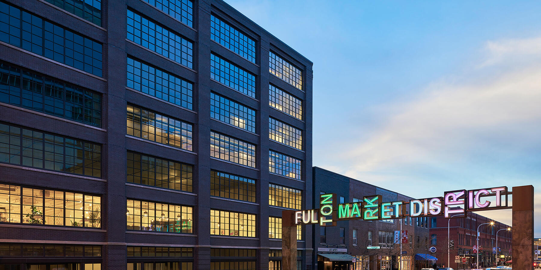 High End Office Construction Chicago - 811 W Fulton exterior view at night with Fulton Market sign