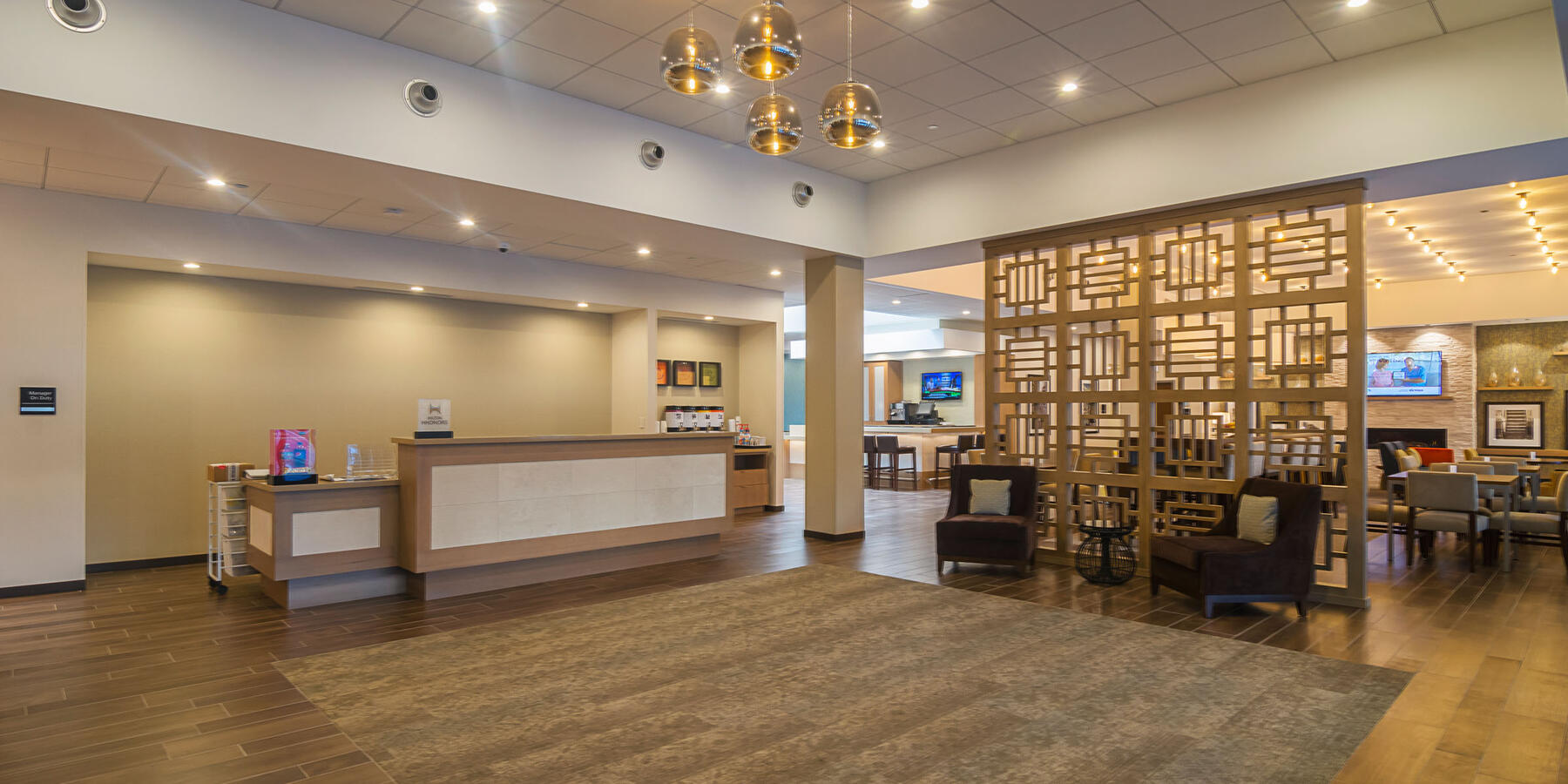 Hospitality Construction Companies - Hampton Inn Loyola lobby with front desk and dining area