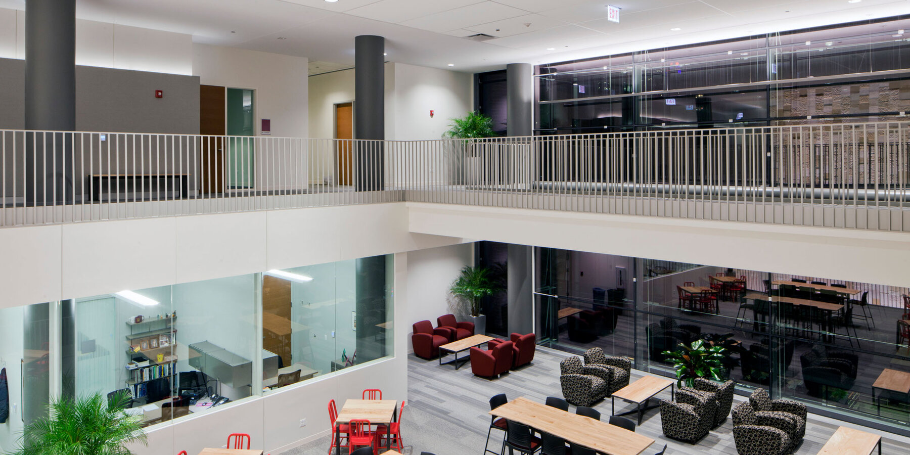 Higher Education Construction - Loyola Schreiber Center Quinlan School of Business two-story open atrium walkway with tables