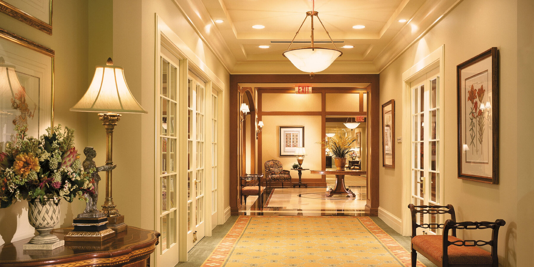 Senior Living Design & Construction - Vi at The Glen hallway with bench