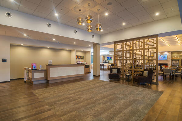 Hospitality Construction Companies - Hampton Inn Loyola lobby with front desk and dining area