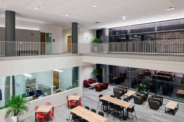 Higher Education Construction - Loyola Schreiber Center Quinlan School of Business two-story open atrium walkway with tables