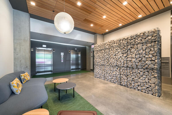 Chicago Apartment Complex Construction - Mica Apartment elevator banks and lobby rock wall feature