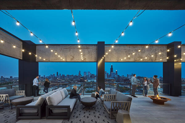 Residential and Multi-Family Construction - The Mason rooftop lounge at dusk with Chicago skyline views
